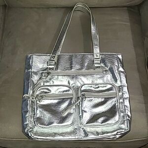 Shiny silver metallic handbag. Outside pockets snap closure‎ clean inside